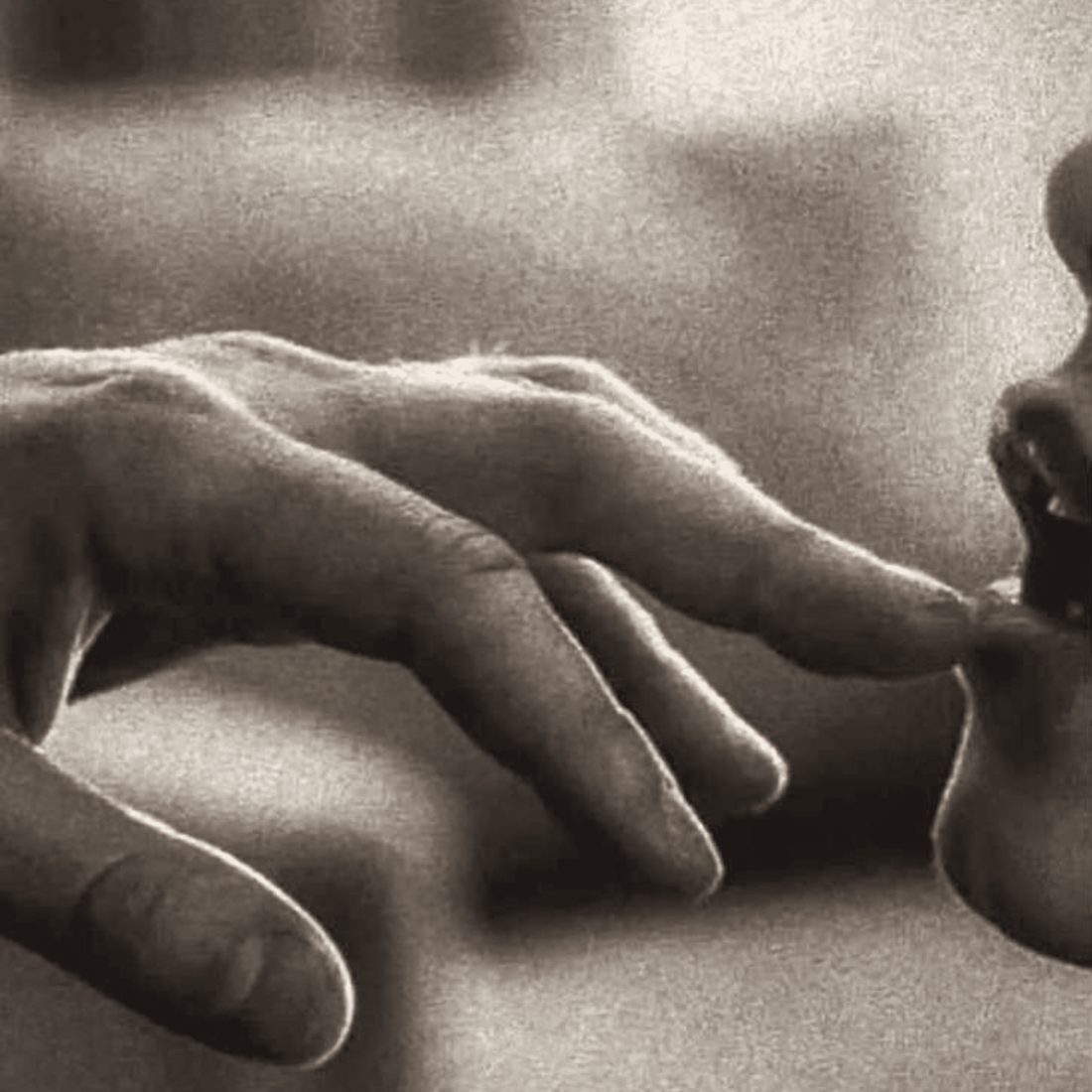 Fingertips gently touching lips